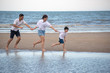 © ic36006 - Happy family on the beach. Parents with Children enjoying a holiday at the sea. Summer vacation concept