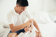 © ic36006 - Happy family. Dad and son playing and laughing in bed room.