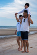 © ic36006 - Happy family on the beach. Parents with Children enjoying a holiday at the sea. Summer vacation concept