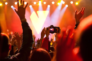 cheering crowd with raised hands at concert - music festival