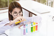 © Suthiporn - Young female scientist student mixing substances in test tube.Copy space.