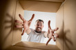 © master1305 - The surprised man unpacking, opening carton box and looking inside. The package, delivery, surprise, gift lifestyle concept. Human emotions and facial expressions concepts