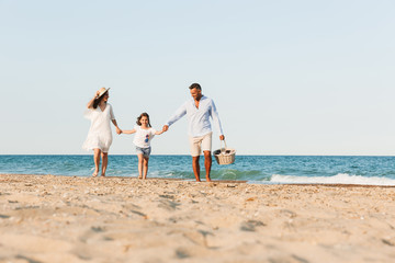 Wall Mural - Happy family having fun together at the beach.