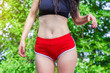 Hips of a girl, slender legs in red shorts panties
