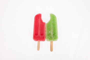 two tasty and refreshing popsicles on white background