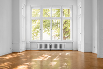 window in empty room, old apartment building with parquet floor