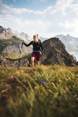 Wall Mural - adventurous sportive girl hiking in beautiful alpine mountains