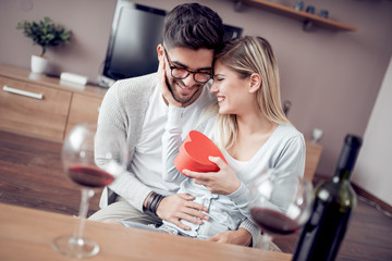 Wall Mural - Young couple with present at home