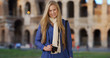 © Mark Adams - Caucasian tourist sightseeing in Rome looks happily at camera near Colosseum
