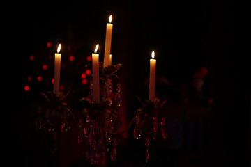 Sticker - Candles lit on sconces and black background