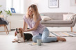 © New Africa - Young woman with her dog at home