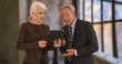 © Mark Adams - Male and female executives using digital tablet in the office