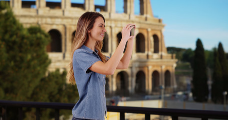 Wall Mural - Smiling woman tourist taking picture on vacation in Rome