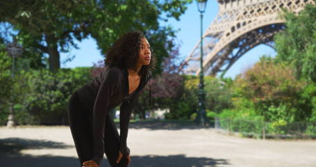 Wall Mural - Black woman athlete in Paris taking a break to catch her breath