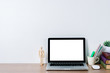 © Mongta Studio - Mock up student desk, Blank screen laptop and student supplies on desk with white wall.