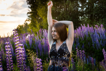 Girl in a field of purple lupines