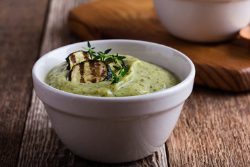 Wall Mural - Healthy zucchini cream soup in ceramic bowls