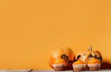 Cupcakes And Pumpkins To Celebrate Halloween On A Background With Space For Text