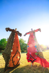 Wall Mural - Young people on stilts posing against the blue sky.