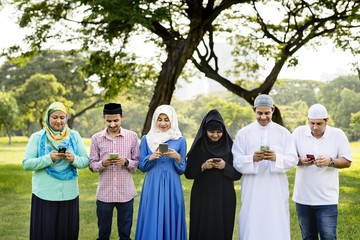 Wall Mural - Muslim family holding smartphones