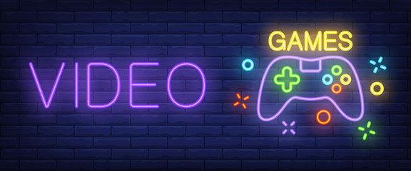 Wall Mural - Video games neon text with controller. Technology and entertainment concept. Advertisement design. Night bright neon sign, colorful billboard, light banner. Vector illustration in neon style.