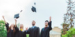 © LIGHTFIELD STUDIOS - portrait of happy multicultural graduates throwing caps up in park