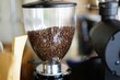 © def2photo - Closed up coffee beans in blender machine at coffee shop