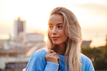 portrait of a pretty young girl with backpack standing