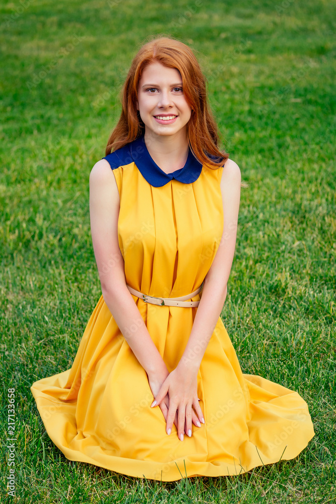 red hair and yellow dress Red-haired Girl in Long Elegant Yellow Dress Stock Photo
