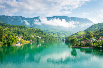 Turquoise lake and mountains with clouds