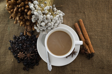 Coffee cup and saucer on a wooden table. Dark background.