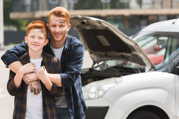 Wall Mural - happy father hugging son after repairing car