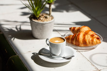 Hot Coffee And Croissant Breakfast In A Sunny Morning, Natural Light.