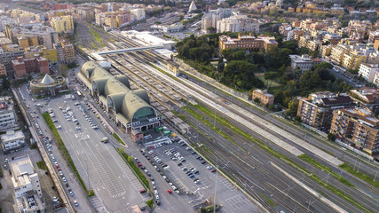 Wall Mural - Aerial view of the Ostiense station in Rome, Italy. There are many tracks, rails and tourists passing by the station. At the bottom we see the Cestia Pyramid.