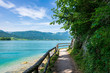 Jetty on the edge of the turquoise lake called Wolfgangsee mountains in the background and clouds on the sky