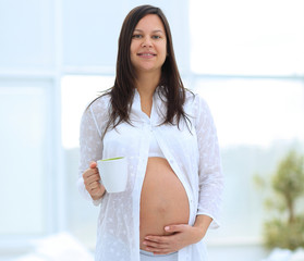 Canvas Print - happy pregnant woman holding Cup of cocoa.