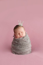 Sleeping Newborn Girl On A Pink Background. Little Princess With Crown. Photoshoot For The Newborn. 7 Days From Birth. A Portrait Of A Beautiful, Seven Day Old, Newborn Baby Girl
