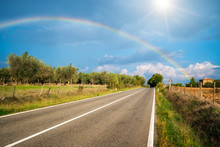 The Rainbow Over Road And Agriculture Landscape.