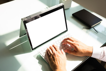 Businessman working on laptop with blank white screen