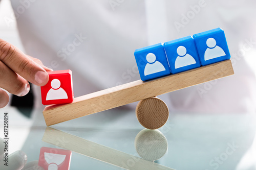Person Showing Unbalance Between Single Red And Blue Blocks Kaufen Sie Dieses Foto Und Finden Sie Ahnliche Bilder Auf Adobe Stock Adobe Stock