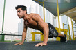 © Artur Ismailov - Young muscular arab athlete doing pushups otdoors in Dubai.