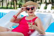 Cute grandmother. Funny cute grandmother with bright red lips drinking refreshing summer cocktail