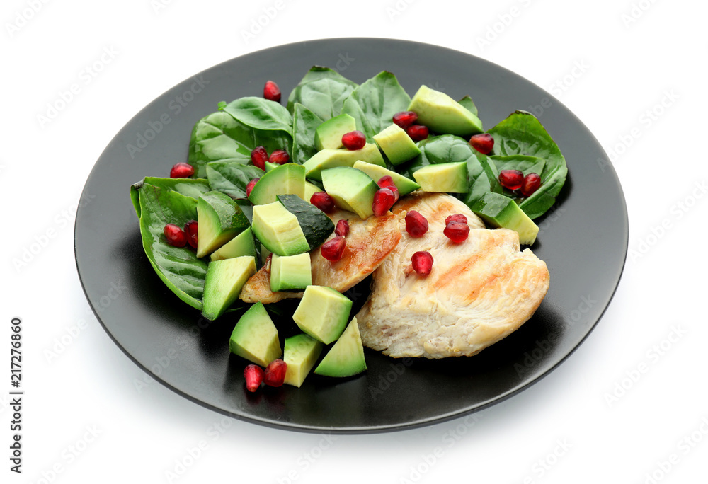 Salad with ripe avocado on plate against white background