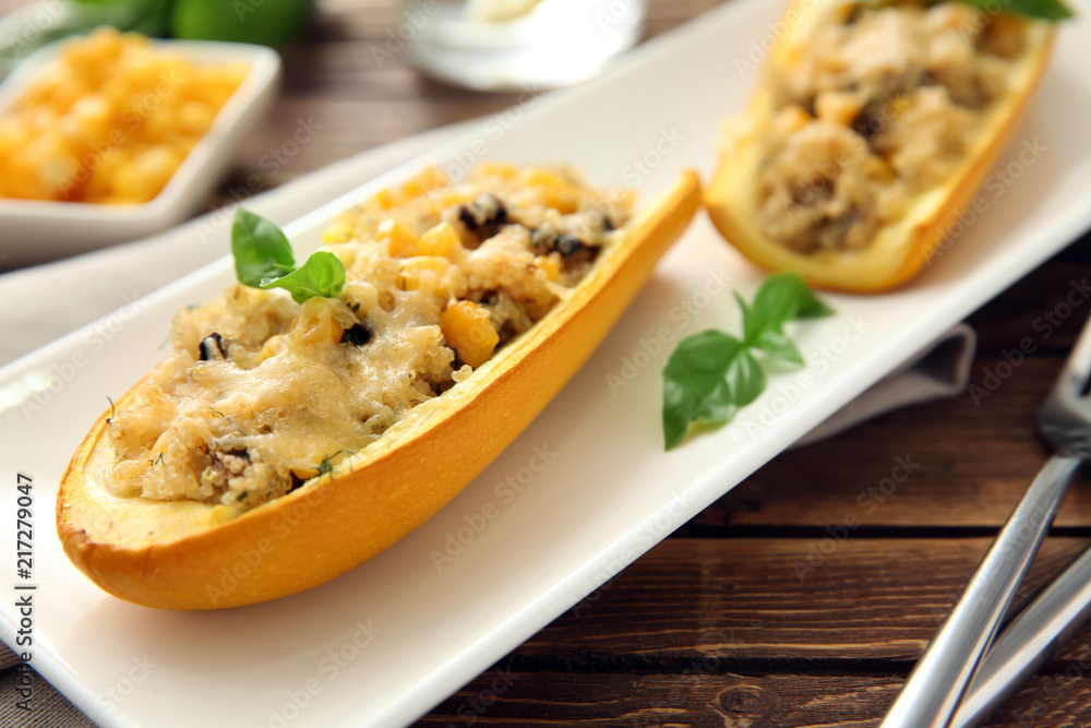 Quinoa stuffed zucchini boats on plate, closeup