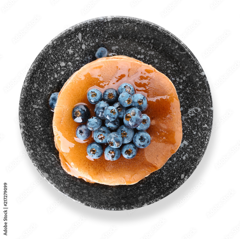 Bowl with tasty pancakes and blueberries on white background