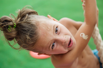 Little boy climbing a rope on the beach