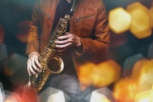 Jazz Saxophone Player In Performance On The Stage. Color Filter And Hexagon Bokeh Added.