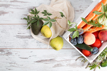 Wall Mural - Zero Waste Home, Vegetable and fruits in white bag on wooden table.