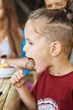 © gorov - boy eating pancake with banana and chocolate