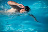 Fototapeta Łazienka - Male swimmer swimming crawl in an outdoor pool - keeping fit
